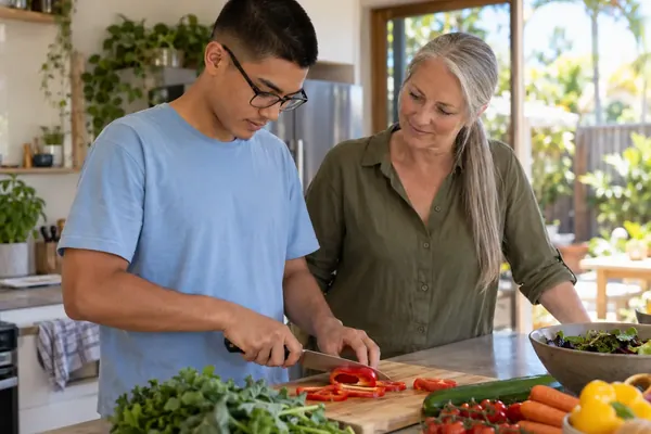 Mentor and young man cooking together in a home kitchen